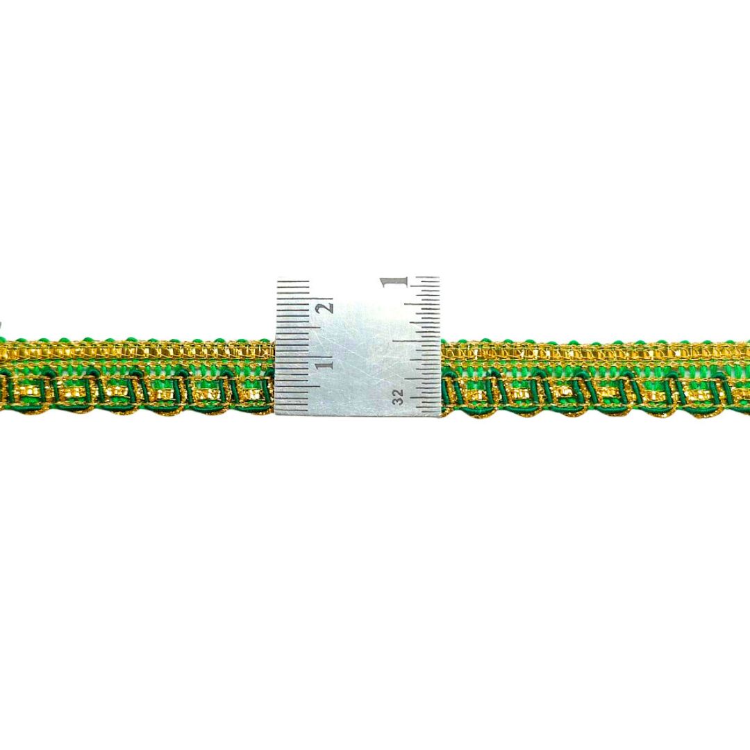 Green and gold braided trim with a ruler for scale on a white background
